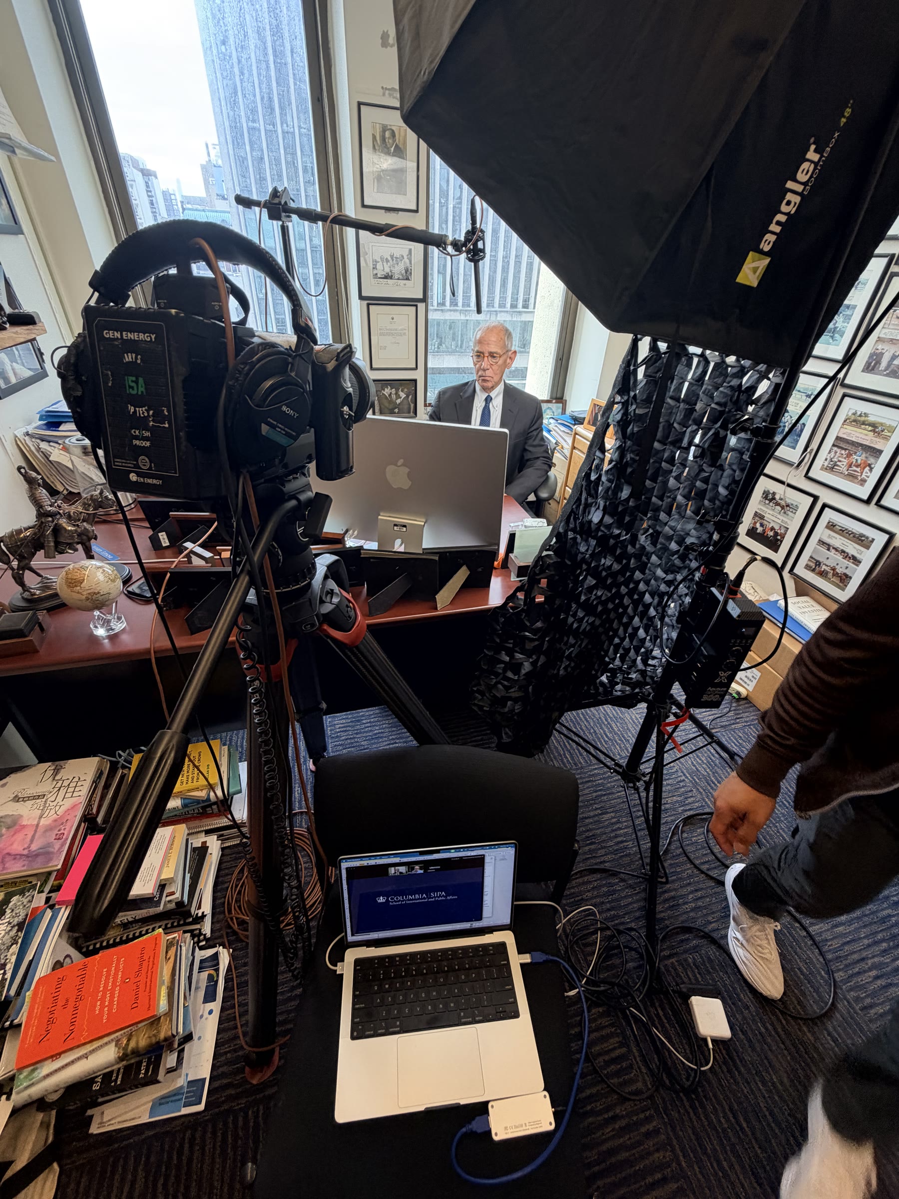 Institutional interview setup with camera, lighting, audio, and laptop monitoring.
